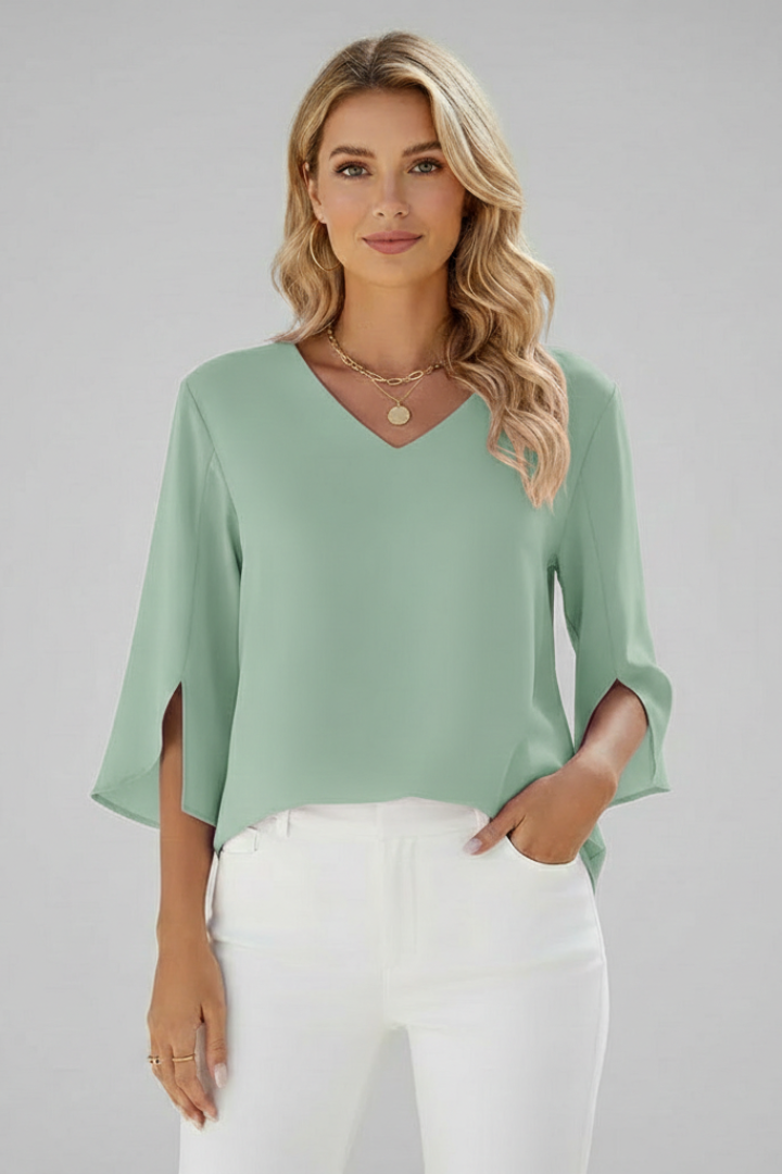 Chic green blouse paired with tailored white trousers
